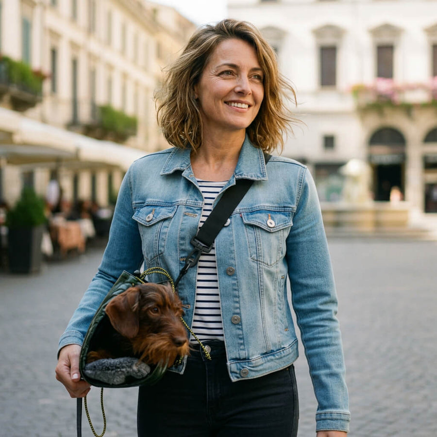 a woman with a dachshund carrying bag