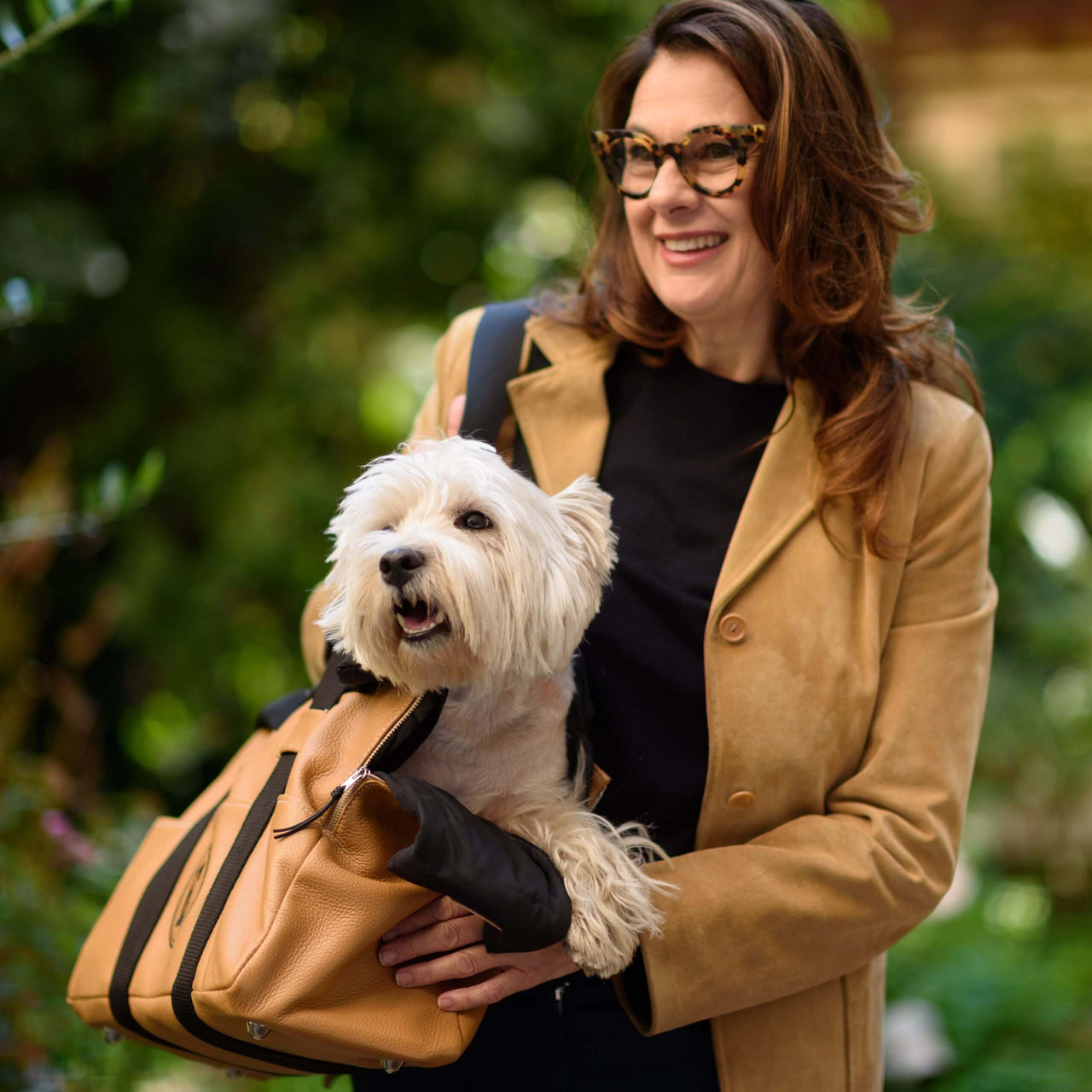 Woman with luxury leather dog carrier purse